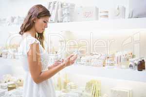 Concentrated woman reading ingredients
