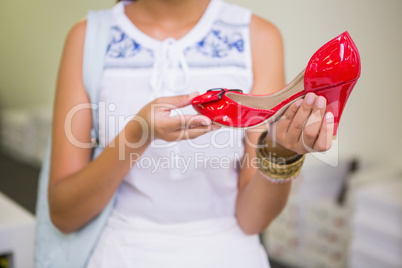Young woman holding a shoe
