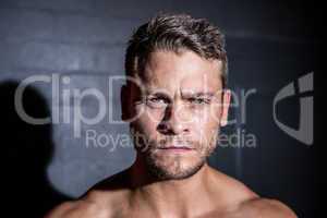 Portrait of serious muscular man looking at camera