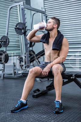 Muscular man drinking protein cocktail Muscular man drinking protein cocktail