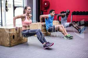 Three young Bodybuilders doing exercises