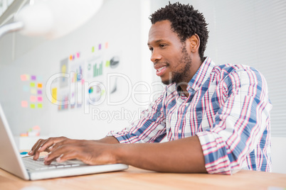 Young businessman types on the laptop