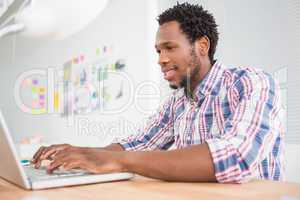 Young businessman types on the laptop