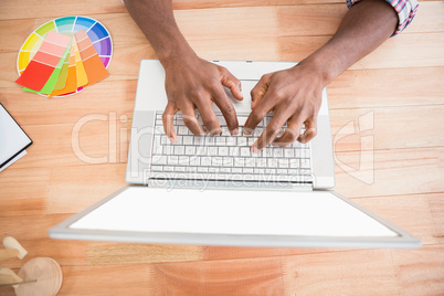 Young businessman writing on the laptop