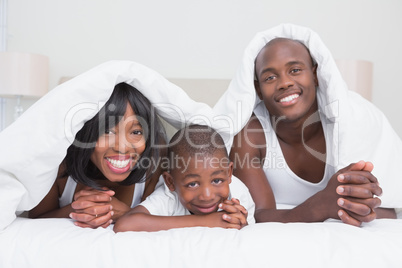 Portrait pretty couple with his son in bed together