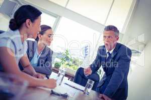 Businessman showing documents during meeting