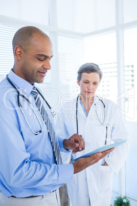 Concentrated medical colleagues working with tablet computer