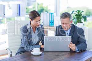 Business people working on laptop computer