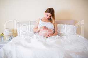 Pregnant woman looking at her belly