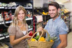 Portrait of smiling bright couple buying food products