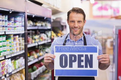 Portrait of a smiling handsome holding a sign