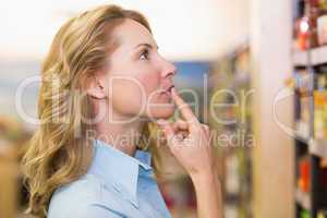 Pretty blonde woman looking at shelves