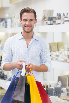 Portrait of a happy smiling man with shopping bags