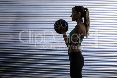 Muscular woman doing ball exercise