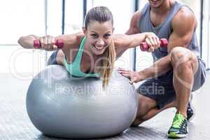 Muscular woman lifting a dumbbell