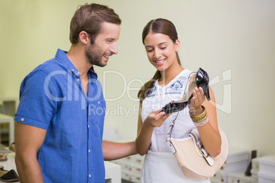 Young happy couple looking at shoes