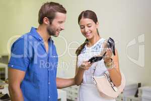 Young happy couple looking at shoes
