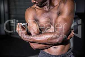 Young Bodybuilder injecting something into his arm