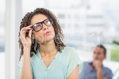 Young businessman looking away in the office