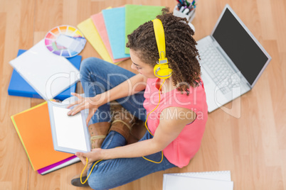 Young creative businesswoman scrolling on tablet