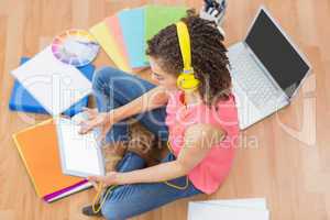 Young creative businesswoman scrolling on tablet