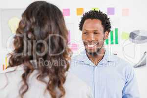 Young smiling business man looking at a woman