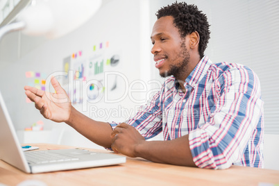 Young businessman sits in front of the laptop