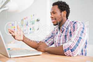 Young businessman sits in front of the laptop