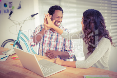 Young business people smiling at each other