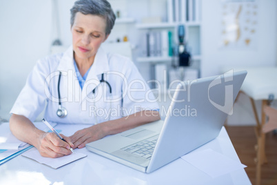 Female doctor writing on paper