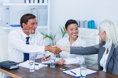 Business people shake hands during meeting