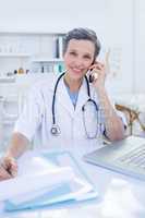 Female doctor having a phone call