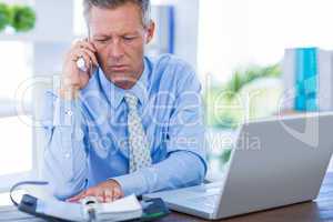 Serious businessman having phone call