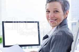 Portrait of smiling businsswoman using computer