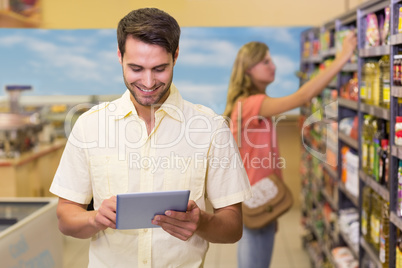 Smiling handsome man using a digital tablet