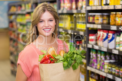 Portrait of smiling pretty blonde woman buying food products