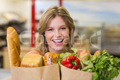 Portrait of pretty smiling blonde woman buying food products