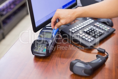 Staff scan a credit card for paying products