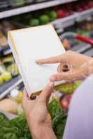 Woman pointing her shopping list