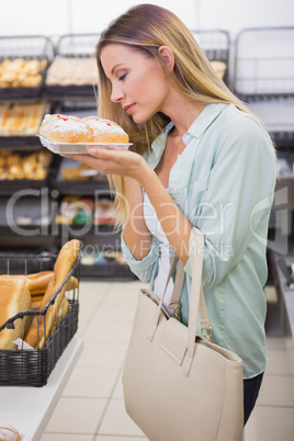 A woman smelling cakes