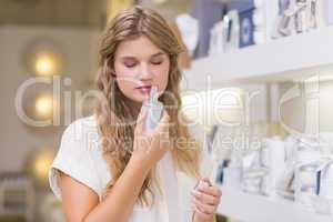 A pretty blonde woman in a perfumery