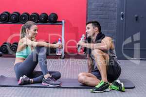 Sitting muscular couple talking together