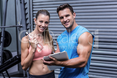 Muscular woman watching her results on clipboard