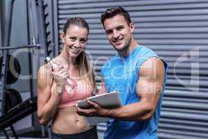 Muscular woman watching her results on clipboard