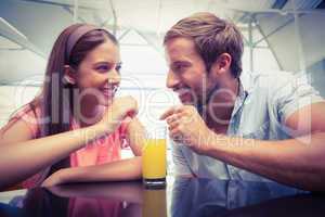 Young happy couple sharing a drink