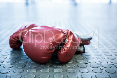 Close up view of boxing gloves on industrial floor