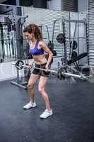 Muscular woman lifting barbell