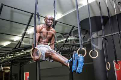 Young Bodybuilder lifting himself up and down