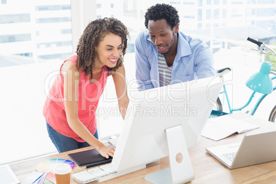 Two creative business colleagues working on the computer