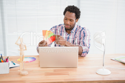 Young businessman looks at colourful cards